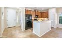 Bright kitchen features warm wood cabinets, tile flooring, and a kitchen island perfect for entertaining at 2722 E Wesson Dr, Chandler, AZ 85286