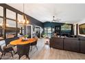 Open concept living room featuring stylish decor, modern lighting, and a fireplace, creating a warm and inviting atmosphere at 2726 S Keene --, Mesa, AZ 85209