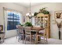 Cozy dining area with large windows, a chandelier, and neutral decor at 3017 S Mesita --, Mesa, AZ 85212