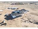 Aerial view of an expansive home under construction, with the roof partially done at 30498 N 232Nd Ave, Wittmann, AZ 85361