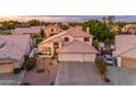 Charming home featuring a tile roof, three car garage, and well-maintained desert landscaping at 3482 W Shannon St, Chandler, AZ 85226