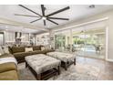 Spacious living room featuring a large ceiling fan, plush sofa, and sliding glass doors to the patio at 3623 E Arabian Dr, Gilbert, AZ 85296