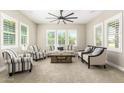 Inviting living room with a ceiling fan, plantation shutters and comfortable seating arrangements at 3623 E Arabian Dr, Gilbert, AZ 85296