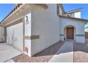 Exterior view of home with a two-car garage, featuring a walkway to the front door at 40564 W Nicole Ct, Maricopa, AZ 85138