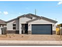 Charming single-story home with a two-car garage and desert landscaping under blue skies at 4264 W Hannah St, San Tan Valley, AZ 85144