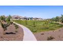 Scenic view of a community park featuring walking trails, a playground, and lush green spaces at 4265 W Hannah St, San Tan Valley, AZ 85144