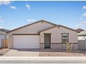 Charming single-story home features a well-manicured front yard and attached two-car garage at 4265 W Hannah St, San Tan Valley, AZ 85144