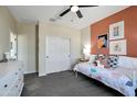 Neutral bedroom with bright decor, plush carpet, white trim, and a closet with sliding doors at 44327 N 43Rd Dr, Phoenix, AZ 85087