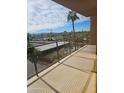 Spacious balcony showcasing city views, palm trees, and distant mountains under a sunny, cloud-filled sky at 4750 N Central Ave # D4, Phoenix, AZ 85012