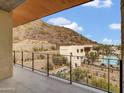 Stunning balcony showcasing a view of the community pool, mountains, and lush landscape at 5000 N Camelback Ridge Dr # 409, Scottsdale, AZ 85251