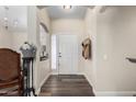 Inviting home foyer with wood flooring and a view into the living spaces at 6401 W Irma Ln, Glendale, AZ 85308