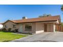 Single-story home featuring a well-maintained lawn and a convenient covered carport at 699 W Shannon St, Chandler, AZ 85225