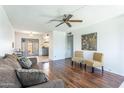 Inviting living room features hardwood floors, ceiling fan, and neutral color palette at 8355 E Thomas Rd, Scottsdale, AZ 85251