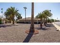 A peaceful suburban street with desert landscaping and mature trees, providing a tranquil setting at 9309 W Briarwood Cir, Sun City, AZ 85351