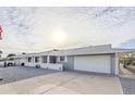 Well-maintained single-story home with a two-car garage, manicured gravel yard, and covered front entrance at 10407 W Mission Ln, Sun City, AZ 85351