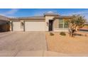 View of the home, showing the driveway, front door, and well-maintained landscaping at 1236 E Silver Reef Dr, Casa Grande, AZ 85122