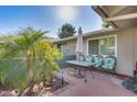 Cozy patio featuring outdoor seating and a lush palm tree, ideal for relaxation at 12515 W Prospect Dr, Sun City West, AZ 85375