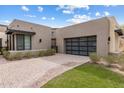 Contemporary home exterior featuring a multi-car garage, desert landscaping, and a paved driveway at 13763 N Campsite Ct, Fountain Hills, AZ 85268