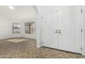 Bright foyer with neutral tile flooring, white walls, and double-door entryway to the home at 14430 W White Rock Dr, Sun City West, AZ 85375