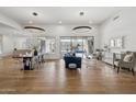 Bright living and dining area featuring hardwood floors, modern lighting, and seamless access to the outdoor pool at 15229 E Marigold Ct, Fountain Hills, AZ 85268