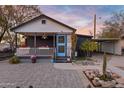 Charming bungalow featuring a covered porch, colorful flower boxes, and a well-maintained front yard at 1546 W Polk St, Phoenix, AZ 85007