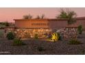 Stonefield community entrance sign with well manicured landscaping at 15683 W Mercer Ln, Surprise, AZ 85379