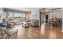 Spacious living room featuring hardwood floors, lots of natural light, and views of the green golf course at 15701 W Huron Dr, Sun City West, AZ 85375