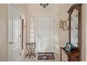 Neutral entryway featuring decorative mirror, decorative rug, and a white entry door at 1651 E Kielly Ln, Casa Grande, AZ 85122