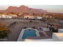 Aerial view of a private pool, patio, and stunning mountain views in a gated desert landscape at 1775 N Starr Rd, Apache Junction, AZ 85119