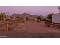 Expansive backyard with crushed rock and wood fence, perfect for outdoor activities at 1775 N Starr Rd, Apache Junction, AZ 85119