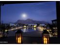 Inviting pool area at night, surrounded by lush greenery and a serene mountain backdrop at 1775 N Starr Rd, Apache Junction, AZ 85119