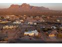 Stunning aerial view of a white home with a pool and mountain views in a desert community at 1775 N Starr Rd, Apache Junction, AZ 85119