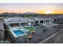 Aerial view showcasing a backyard oasis with a pool, spa, and artificial turf at 18024 E Wolf Tree Ln, Rio Verde, AZ 85263