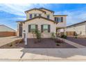 Beautiful exterior elevation featuring a manicured yard with a stone accent and covered porch at 18609 W Diana Ave, Waddell, AZ 85355