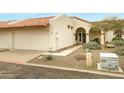 Quaint property showcasing a terra cotta roof, attached garage, and lovely front garden at 1930 S Westwood Dr # 29, Mesa, AZ 85210