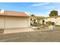 Inviting home featuring an attached garage, arched entryway, and xeriscaped front yard at 1930 S Westwood Dr # 29, Mesa, AZ 85210