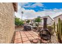 Charming backyard featuring a tiled area, desert landscaping, and a rustic chiminea at 1973 E Buena Vista Dr, Chandler, AZ 85249