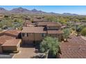 Gorgeous desert homes feature tile roofs and beautiful landscaping with mountain views in this aerial view at 20704 N 90Th Pl # 1065, Scottsdale, AZ 85255