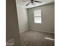 Cozy bedroom featuring a ceiling fan and a window with blinds for natural light at 2344 E Alida Trl, Casa Grande, AZ 85194