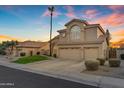 Inviting home with lush green lawn, tall palm tree and a convenient three-car garage at 2419 E Goldenrod St, Phoenix, AZ 85048