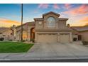 Stunning front exterior showcasing a meticulously landscaped lawn and a three-car garage at 2419 E Goldenrod St, Phoenix, AZ 85048