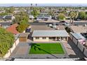 Backyard aerial view, including manicured lawn, brick patio, and privacy fence at 2525 E Nisbet Rd, Phoenix, AZ 85032