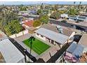 Aerial view of home featuring backyard with artificial lawn, covered patio, and desert landscaping at 2525 E Nisbet Rd, Phoenix, AZ 85032