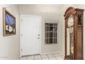 Bright foyer featuring a white front door and a stained glass picture to the left at 26681 S Howard Dr, Sun Lakes, AZ 85248