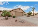 Exterior view of a single story home showcasing the two car garage and desert landscaping at 26681 S Howard Dr, Sun Lakes, AZ 85248