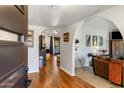 Inviting entryway with hardwood floors, arched doorways, and views into the living spaces at 301 E Carol Ann Way, Phoenix, AZ 85022