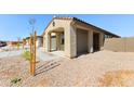 Inviting single-story home exterior with a covered porch, low-maintenance landscaping, and cozy, neighborhood charm at 37582 W San Clemente St, Maricopa, AZ 85138