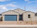 Charming single-story home featuring a blue garage door and inviting front entrance at 4280 W Hannah St, San Tan Valley, AZ 85144