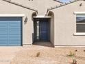 Welcoming front entrance with a blue door, side window, and a brick walkway at 4280 W Hannah St, San Tan Valley, AZ 85144