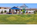 Community playground featuring shade structure, picnic tables, BBQ grills, a slide, and benches at 4281 W Hannah St, San Tan Valley, AZ 85144